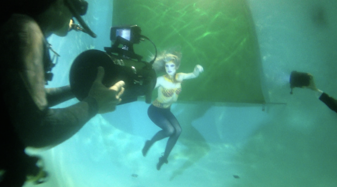 Behind the scenes proof of concept image showing an underwater camera operator filming a mermaid model in a pool for the Wild Mermaids project